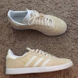 Beige adidas shoes.